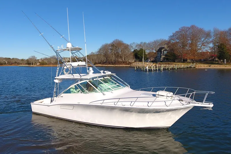 Slide: The Image of 2004 Cabo Express boat on calm water with clear blue sky. - 2