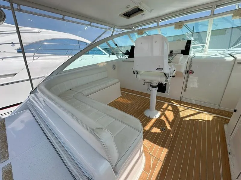 Slide: The Image of 2004 Cabo Express boat interior with white seating and wooden flooring. - 26