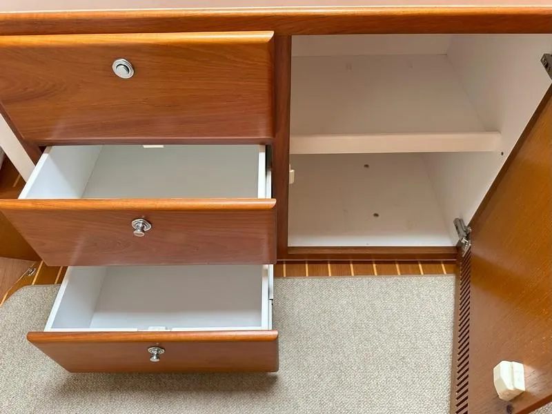 Slide: The Image of Wooden cabinet with open drawers and shelves, Cabo Express 2004 model. - 41