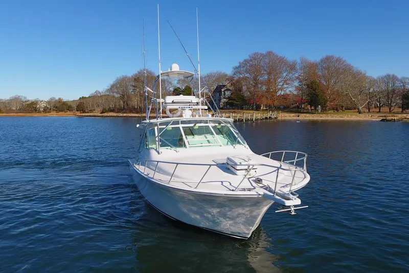 Slide: The Image of 2004 Cabo Express boat on calm water with clear blue sky. - 11