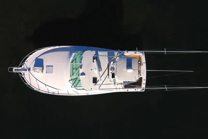 Slide: The Image of Aerial view of 2004 Cabo Express boat on dark water. - 13