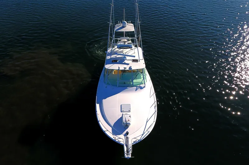 Slide: The Image of Aerial view of 2004 Cabo Express boat on calm water. - 14