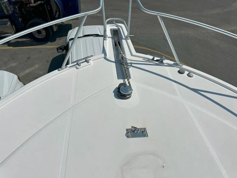 Slide: The Image of Bow view of a 2004 Cabo Express boat with anchor chain and railing. - 17