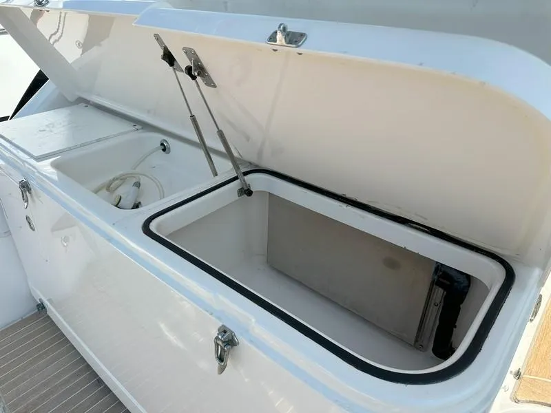 Slide: The Image of Open storage compartment on a 2004 Cabo Express boat, showcasing interior space. - 22