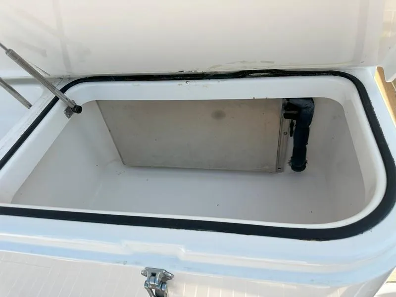 Slide: The Image of Open storage compartment on a 2004 Cabo Express boat, showing interior details. - 23