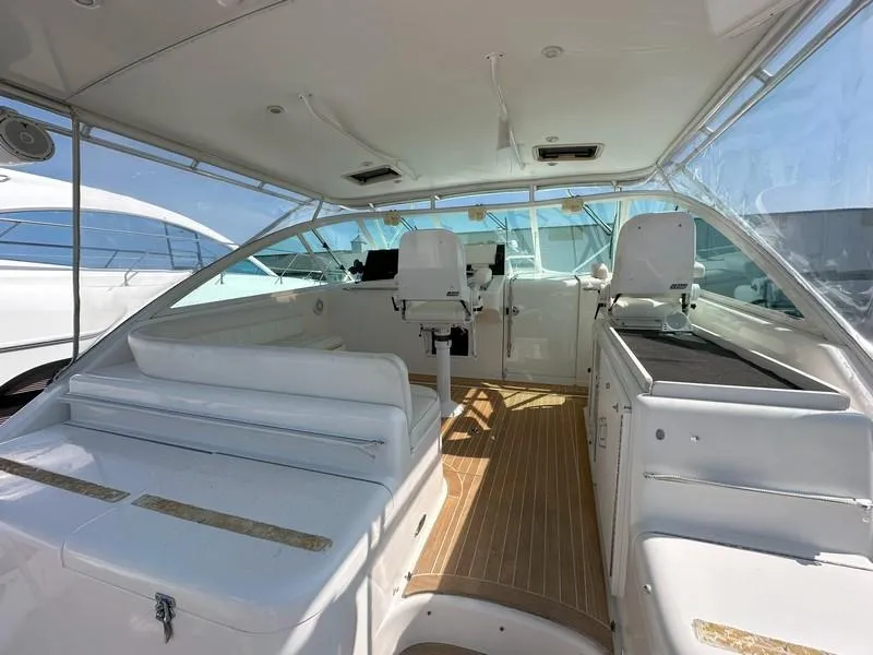Slide: The Image of 2004 Cabo Express boat interior with white seating and wooden flooring. - 24