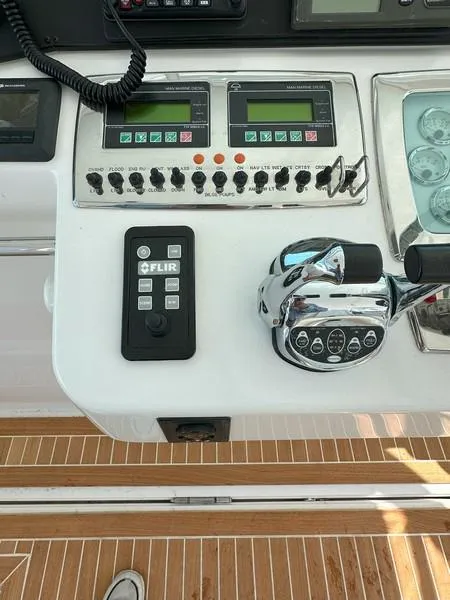 Slide: The Image of Control panel of a 2004 Cabo Express boat with FLIR system and throttle controls. - 32