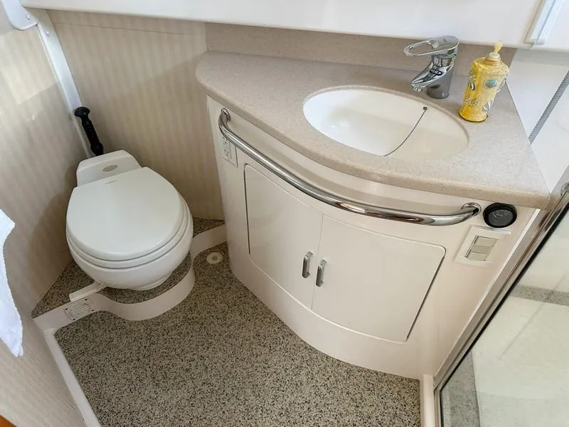 Slide: The Image of Compact bathroom in a 2004 Cabo Express boat with sink and toilet. - 49