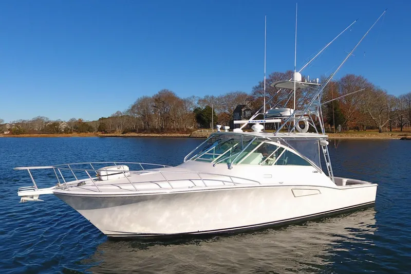 Slide: The Image of 2004 Cabo Express boat on calm water under clear blue sky. - 8