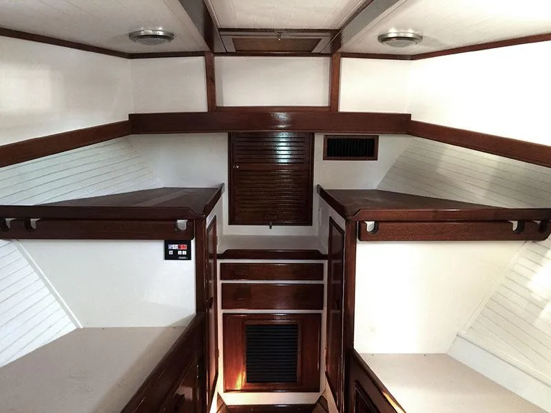 Slide: The Image of Interior of 1934 Classic Cruiser Hemingway's Pilar Replica, featuring wooden finishes and cozy cabin layout. - 11