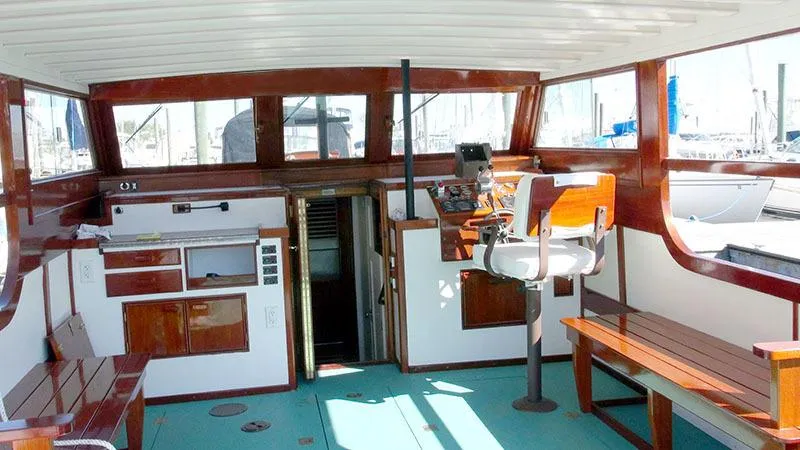 Slide: The Image of Interior of 1934 Classic Cruiser Hemingway's Pilar Replica, featuring wooden accents and nautical equipment. - 16