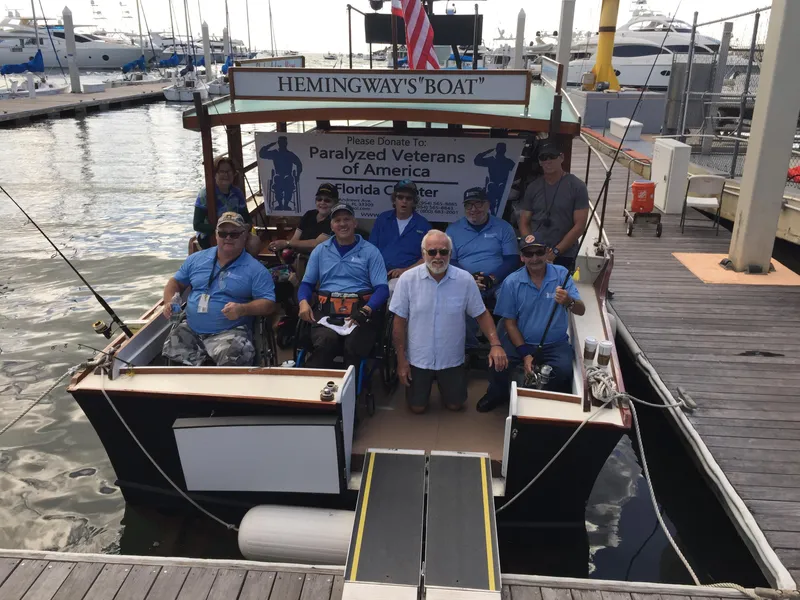 Slide: The Image of Group on Hemingway's Pilar Replica boat, 1934 Classic Cruiser, supporting Paralyzed Veterans of America. - 18