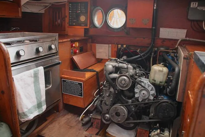Slide: The Image of 1958 Concordia Yawl interior with engine, stove, and portholes. - 11