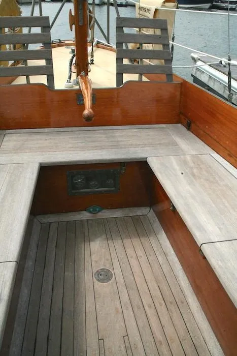 Slide: The Image of 1958 Concordia Yawl boat cockpit with wooden seating and flooring. - 12