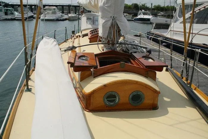 Slide: The Image of 1958 Concordia Yawl sailboat deck with wooden cabin and portholes in marina. - 15