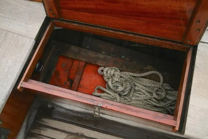 Slide: The Image of Open storage compartment on 1958 Concordia Yawl with coiled rope inside. - 16