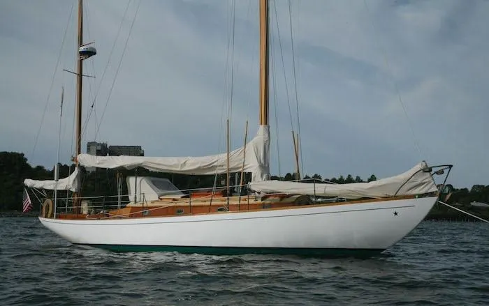 Slide: The Image of 1958 Concordia Yawl sailboat on calm waters with sails down. - 2