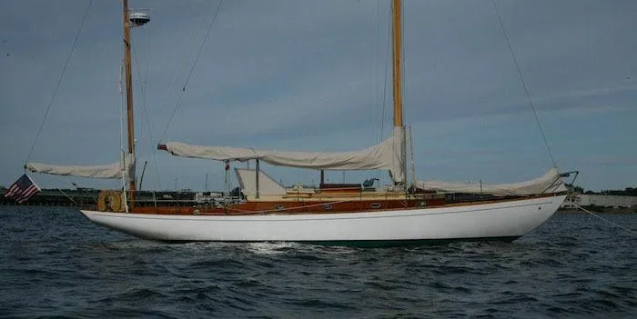 Slide: The Image of 1958 Concordia Yawl sailboat on the water with sails down. - 22