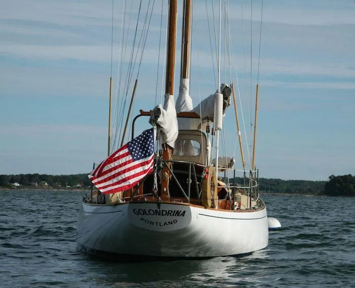 Slide: The Image of 1958 Concordia Yawl Golondrina sailing with American flag in Portland waters. - 4