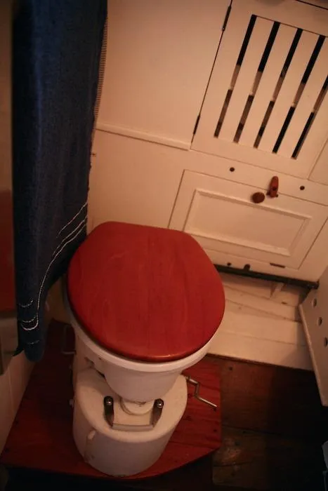 Slide: The Image of 1958 Concordia Yawl wooden boat bathroom with vintage toilet and cabinetry. - 6