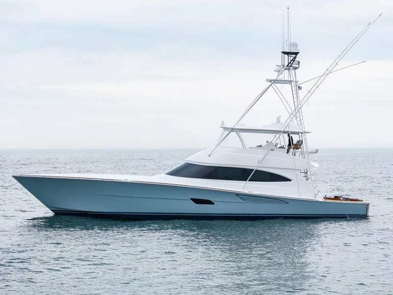 Slide: The Image of 2024 Viking 82 Convertible yacht on calm ocean waters. - 2