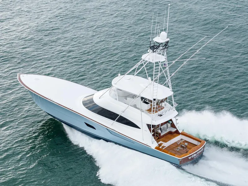 Slide: The Image of 2024 Viking 82 Convertible yacht cruising on open water. - 5