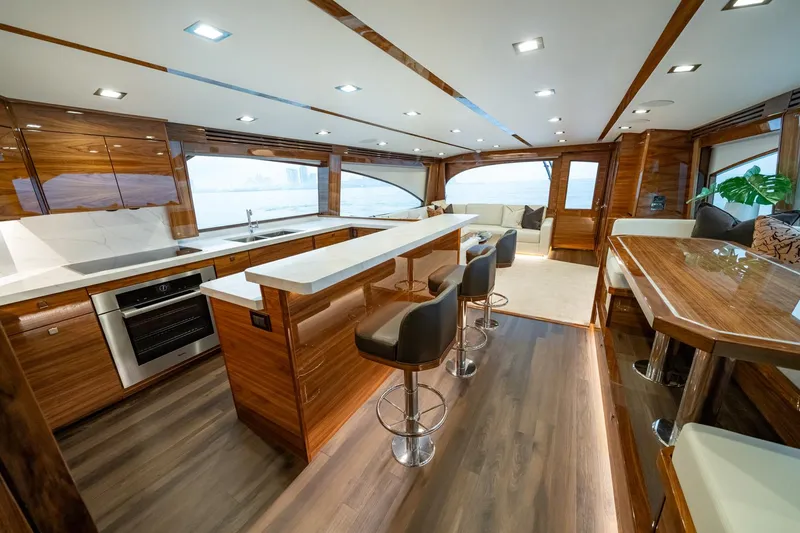 Slide: The Image of Luxurious interior of 2024 Viking 82 Convertible yacht with modern kitchen and seating area. - 7