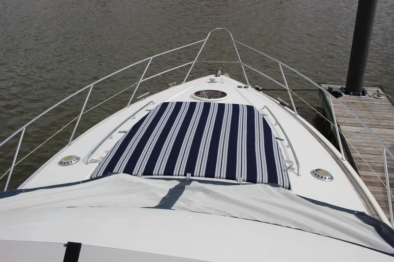 Slide: The Image of 2006 Fairline Phantom yacht bow with striped sun pad at dock. - 13