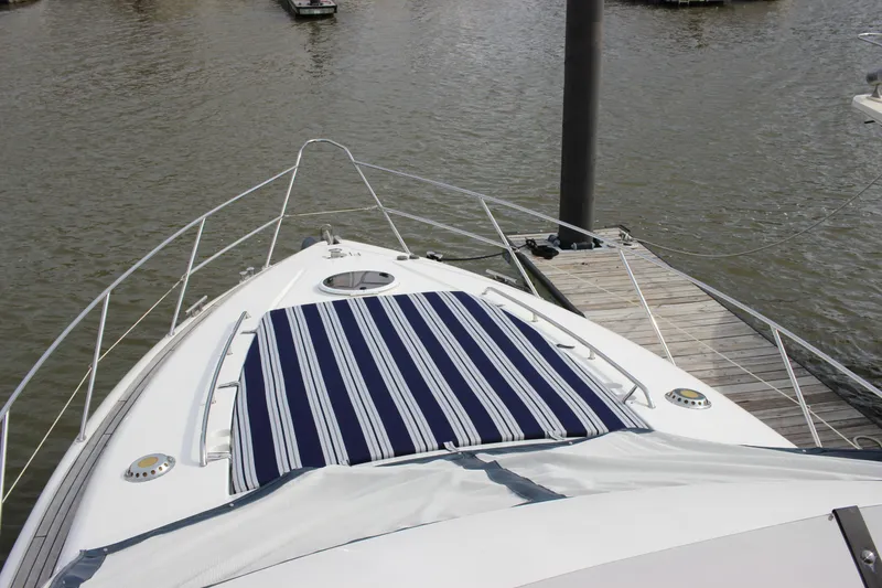 Slide: The Image of 2006 Fairline Phantom yacht bow with striped sun pad at dock. - 14