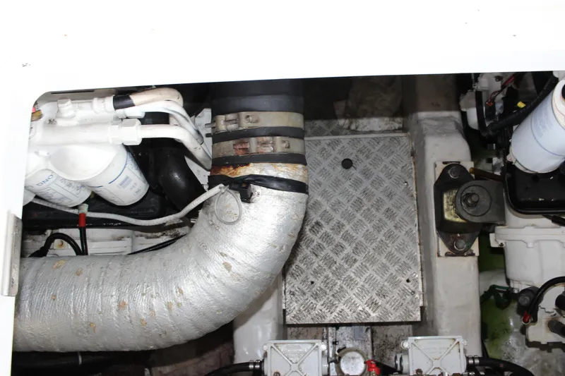 Slide: The Image of Engine compartment of a 2006 Fairline Phantom yacht showing exhaust and mechanical components. - 26