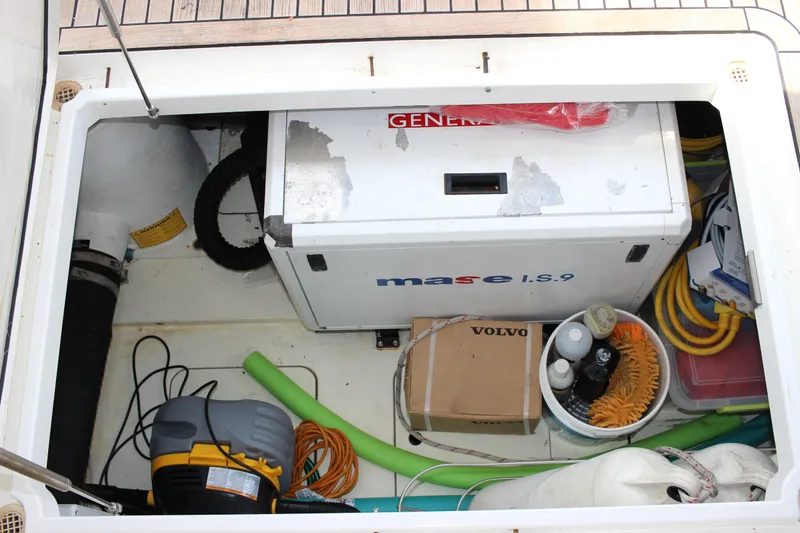 Slide: The Image of Storage compartment of a 2006 Fairline Phantom boat with generator and equipment. - 30