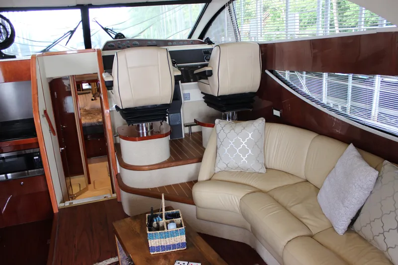 Slide: The Image of Interior of a 2006 Fairline Phantom yacht with beige leather seating and modern helm chairs. - 38
