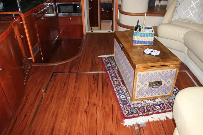 Slide: The Image of Interior of 2006 Fairline Phantom yacht with wooden flooring and cozy seating area. - 40