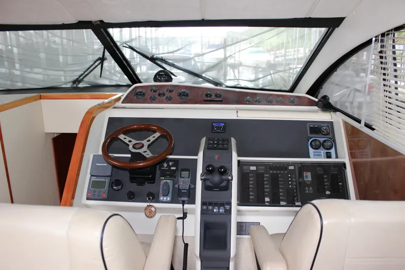 Slide: The Image of 2006 Fairline Phantom yacht helm with modern navigation controls and leather seats. - 42