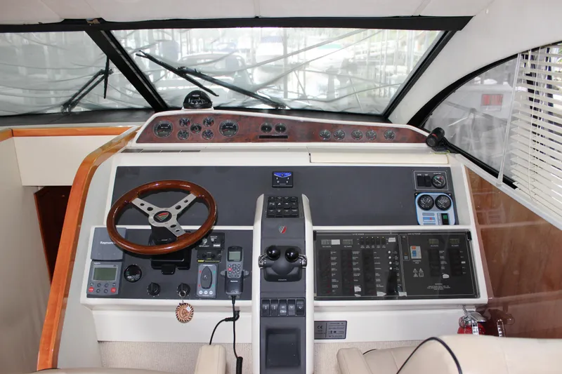 Slide: The Image of Fairline Phantom 2006 yacht helm with steering wheel and control panels. - 43