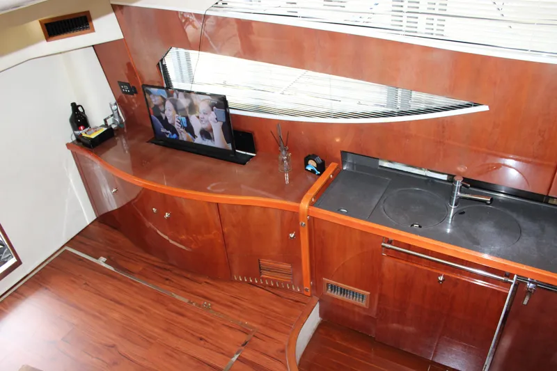Slide: The Image of Interior of 2006 Fairline Phantom yacht with wooden cabinetry and modern amenities. - 45