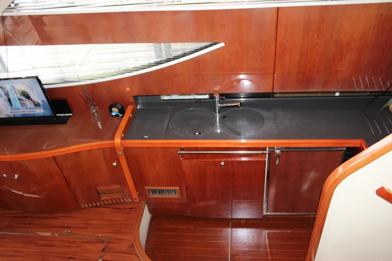 Slide: The Image of Modern kitchen area in 2006 Fairline Phantom yacht with wooden cabinetry and sleek countertops. - 46