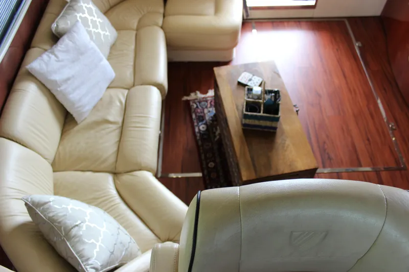 Slide: The Image of Luxurious interior of a 2006 Fairline Phantom yacht with leather seating and wooden table. - 48