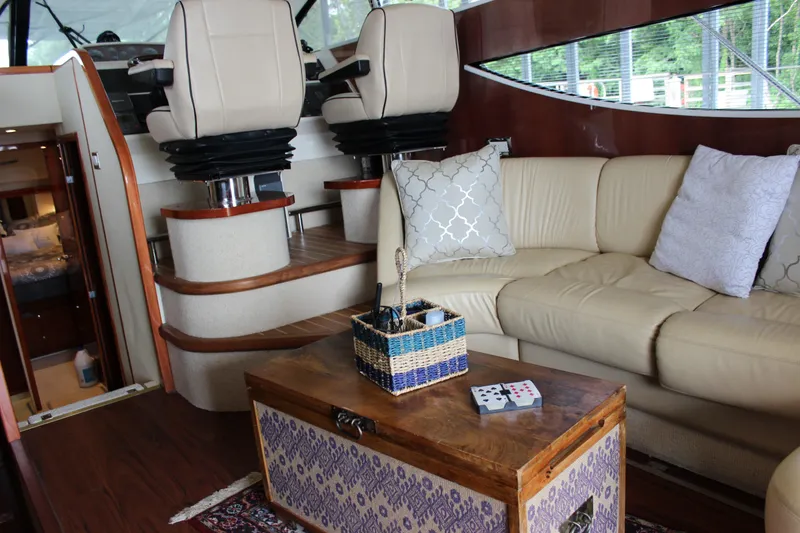 Slide: The Image of Luxurious interior of a 2006 Fairline Phantom yacht with leather seating and wooden accents. - 49