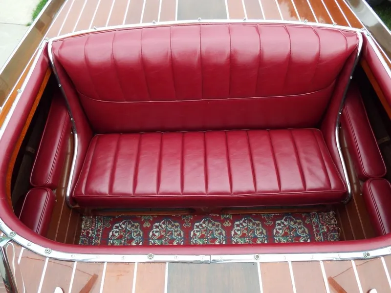 Slide: The Image of 1928 Hacker-Craft Dolphin boat with red leather seating and wooden deck. - 10