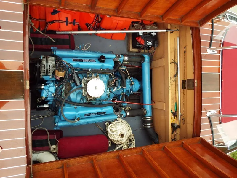 Slide: The Image of 1928 Hacker-Craft Dolphin engine, vintage blue machinery, wooden boat interior. - 13
