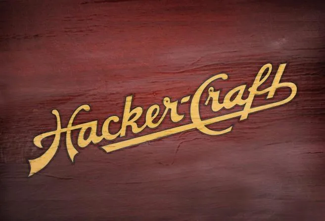 Slide: The Image of Vintage 1928 Hacker-Craft Dolphin logo on wooden background. - 18
