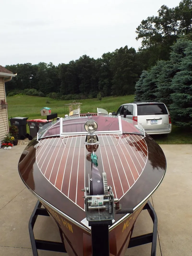 Slide: The Image of 1928 Hacker-Craft Dolphin boat with polished wood finish on a trailer. - 5
