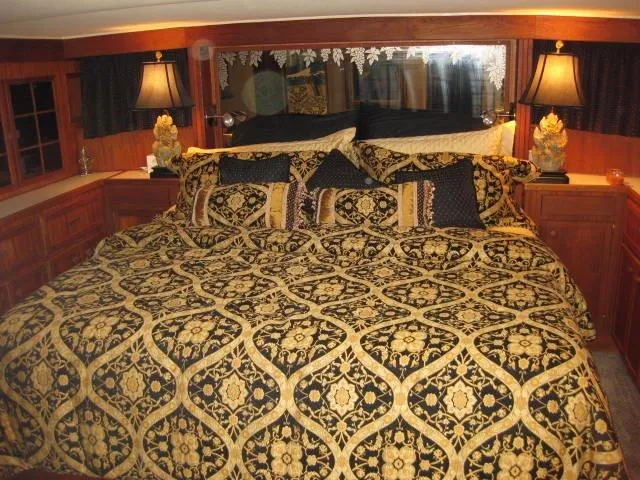 Slide: The Image of Luxurious bedroom interior on 1984 Chris-Craft Constellation yacht with ornate bedding and elegant lamps. - 12
