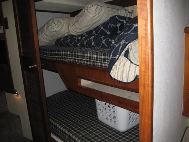 Slide: The Image of Bunk beds in 1984 Chris-Craft Constellation boat cabin with plaid bedding and pillows. - 20