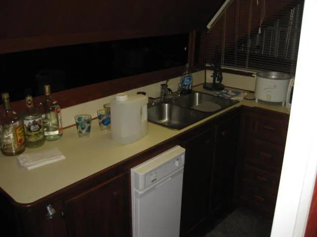 Slide: The Image of 1984 Chris-Craft Constellation kitchen with sink, countertop, and appliances. - 24