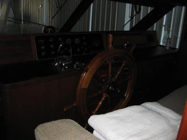 Slide: The Image of 1984 Chris-Craft Constellation helm with wooden steering wheel and instrument panel. - 28