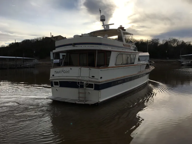 Slide: The Image of 1984 Chris-Craft Constellation yacht on calm water at sunset. - 3