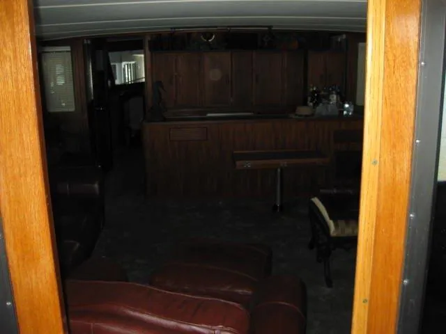 Slide: The Image of Interior of 1984 Chris-Craft Constellation yacht with wooden furnishings and leather seating. - 30