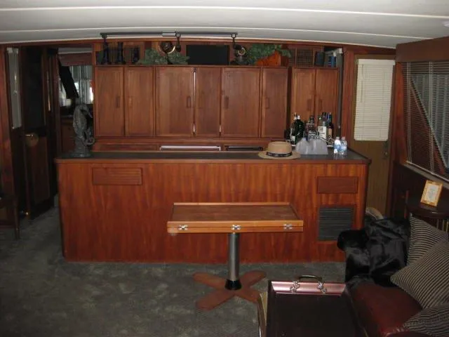 Slide: The Image of 1984 Chris-Craft Constellation interior with wooden cabinetry and bar area. - 33
